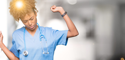 Wall Mural - Young african american doctor woman over isolated background stretching back, tired and relaxed, sleepy and yawning for early morning