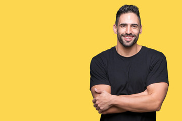 Young handsome man over isolated background happy face smiling with crossed arms looking at the camera. Positive person.