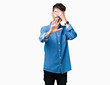 © Krakenimages.com - Young handsome man over isolated background covering eyes with hands and doing stop gesture with sad and fear expression. Embarrassed and negative concept.