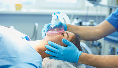 Several doctors surrounding patient on operation table during t