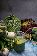 view of a pitcher of tasty green smoothie of fresh vegetables for vegans