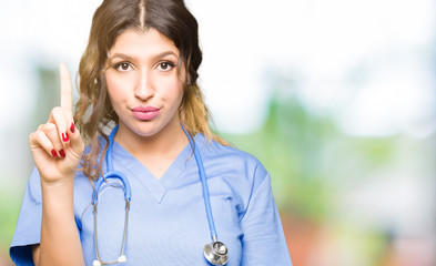 Poster - Young adult doctor woman wearing medical uniform Pointing with finger up and angry expression