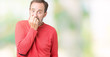 © Krakenimages.com - Handsome middle age hoary senior man wearing winter sweater over isolated background looking stressed and nervous with hands on mouth biting nails. Anxiety problem.
