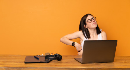 Wall Mural - Business woman in a office suffering from backache for having made an effort