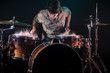 © puhimec - musician playing drums with splashes, black background with beautiful soft light