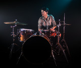 Fototapeta  - musician playing drums, black background and beautiful soft light