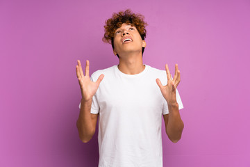 Wall Mural - Young african american man over isolated purple wall frustrated by a bad situation