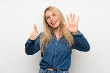 Young blonde woman over isolated white wall counting six with fingers