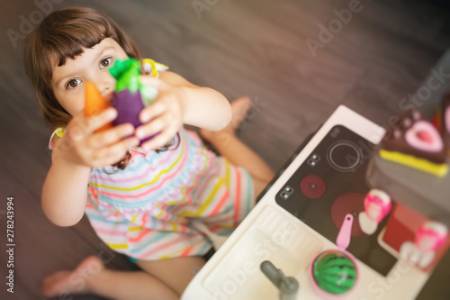 little girl play dishes