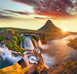 Beautiful landscape with old compass on traveler's hand. Traveling concept.