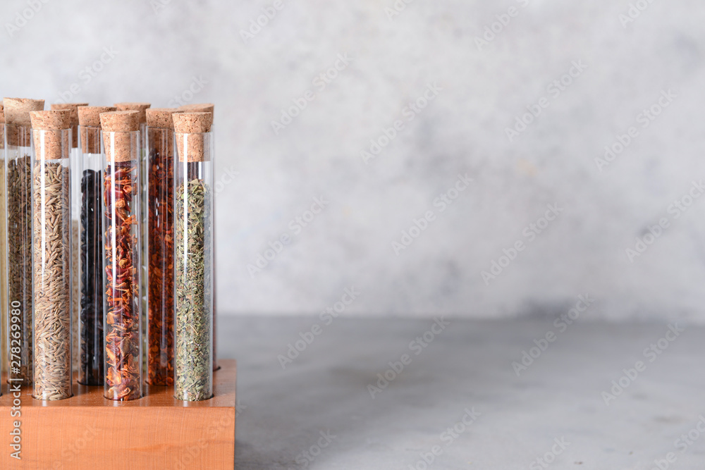 Assortment of spices in tubes on grunge background