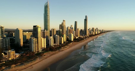 Canvas Print - Apartments, hotels and business towers on Australian Gold Coast Surfers paradise facing Pacific ocean over sandy beach and surfing waves.