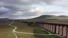 Aerial Shot Pushing In On Ribblehead Viaduct & Train Station In The Yorkshire Dales National Park