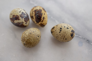 composition with small quail eggs in the bowl on the black wooden background