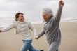 © Bonninstudio/Stocksy - Active senior woman and her daughter enjoying on the beach in winter.
