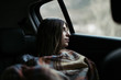 © Javier Pardina/Stocksy - Younger woman thinking and enjoying at travel by car.