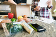 © Sean Locke Photography/Stocksy - Meal: Couple Removing Ingredients From Box And Looking At Recipe