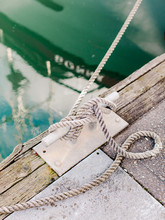 Close Up Of Knot Of Boat Tied At Dock