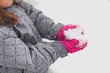 © Goodness Grace Photography/Stocksy - Smiling girl with bright pink hat plays in snow