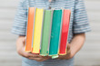 © Alicia Brown/Stocksy - Little boy holding a book rainbow