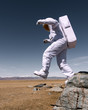 © Alexandr Ivanets/Stocksy - Astronaut jumping down from mountain