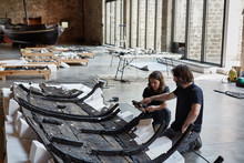Two Restorers Working In A Sailing Museum