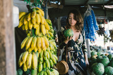 Woman Traveler Browsing A Fresh Fruit Market On Vacation