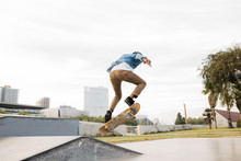 Active Hipster Jumping On Skateboard