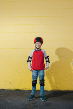 Kid Wearing Bike Gear And Helmet.