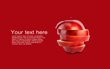 Stack of red apple sliced on red background with copy space and sample text