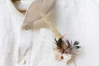 © matousekfoto - Groom wedding shirt with feather and grass decoration, vintage natural, country style
