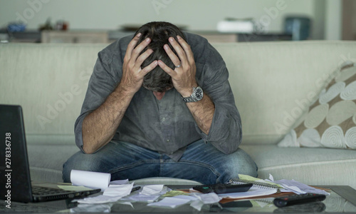 Cuadros en Lienzo stressed and desperate man at home living room couch doing domestic accounting w