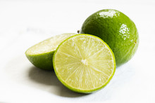 Fresh Green Limes On White Background
