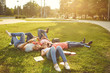 © Studio Romantic - Young people are laughing while lying on the grass