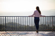 © Gabriel - Beautiful woman back shot on a viewpoint railing with blurred background
