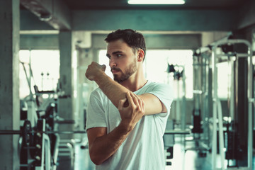 Handsome Healthy Man is Warm-Up Exercised Before Working Out in Fitness Sport Club.,Portrait of Strong Man Doing Exercising Calories Burning in Gym., Sport Healthy and Fitness Lifestyle Concept.