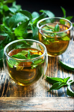 Two Glass Cups With Fresh Mint Tea On Wooden Table