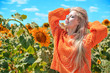 © Alona - Beautiful caucasian woman posing on meadow with sunflowers.