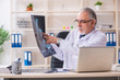 © Elnur - Aged male doctor radiologist in the clinic