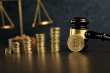 Auction Gavel And Bitcoin Cryptocurrency Money On A Wooden Desk, Close-up. Law Gavel And Golden Bitcoin Symbol On White Background With Copyspace