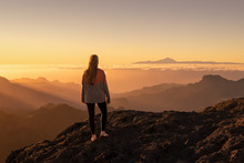 Happy Young Woman Standing And Enjoying Life At Sunset In Mountains - Gran Canaria, Spain