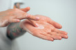 © Artem Markin - Fingers apply cream to skin. Close up