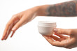 © Artem Markin - Female tattooed hands holding a jar of cream