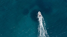 Aerial Bird's Eye View Of Inflatable Rib Boat Cruising In High Speed In Turquoise Clear Water Sea