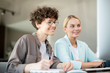 © pressmaster - Two happy female colleagues looking at data on computer screen