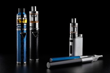 Wall Mural - electronic cigarettes or vaping devices on black background