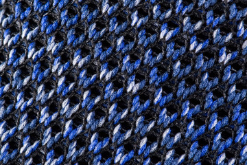 Fragment of a blue cloth sneaker. The texture of the material of sports shoes