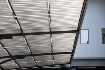 Wall Mural - silver metal roof of small car park. grey steel roofing.