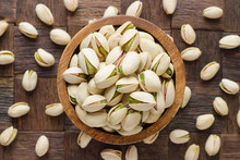 Shelled Pistachio Nuts In Wooden Bowl, Top View.