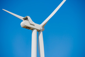 Wind Generator Turbine on the Blue Sky Bacground. Green Renewable Energy Concept.